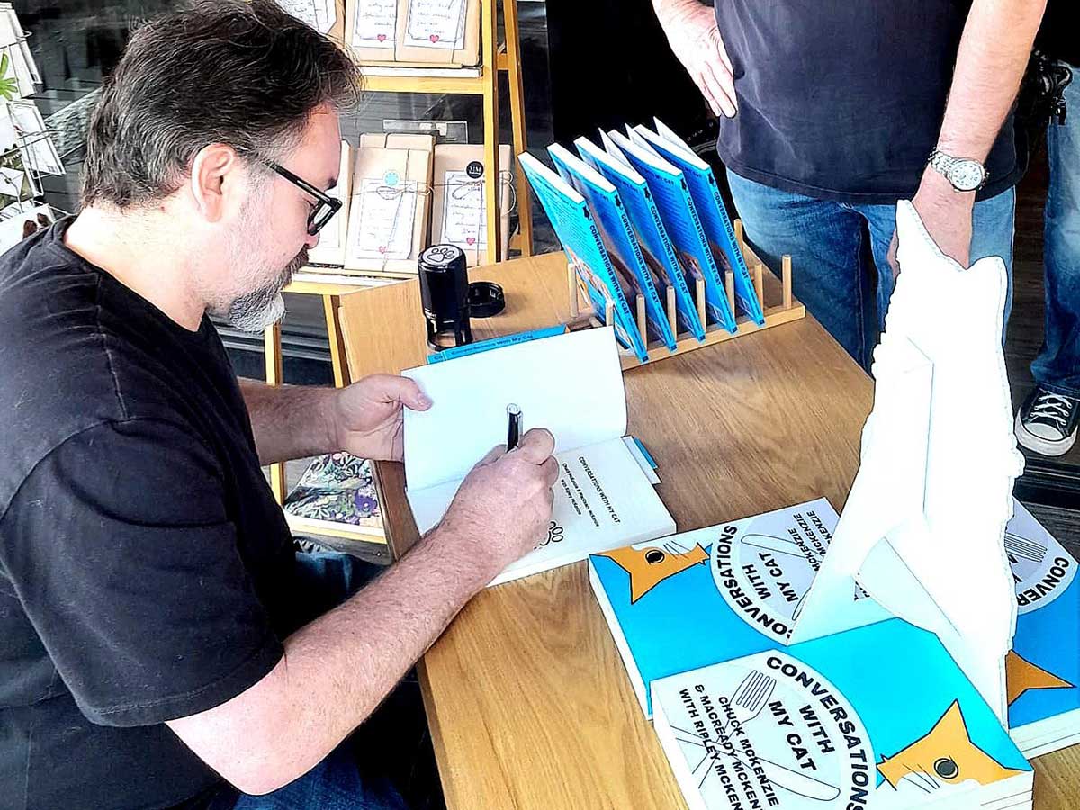 Chuck McKenzie signing book